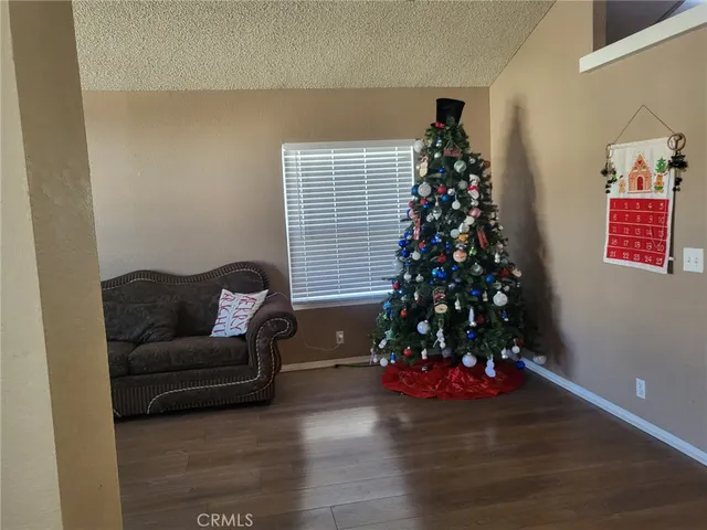 a living room with furniture and a christmas tree