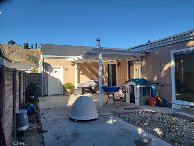 a view of a tables and chairs in backyard