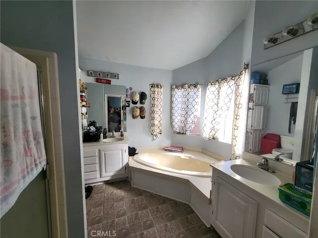 a bathroom with a tub sink and mirror