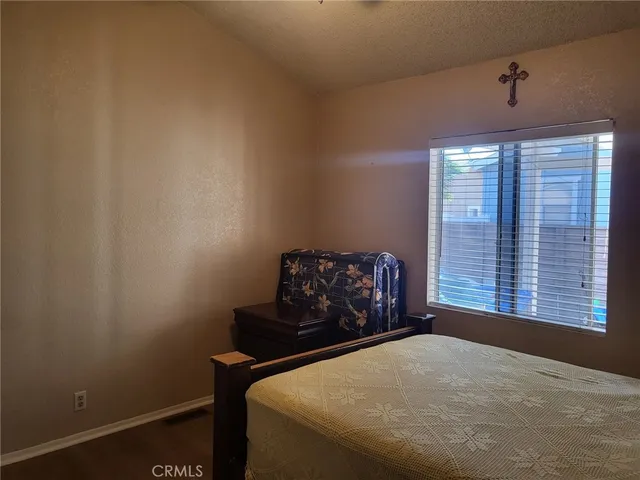 a bed sitting in a bedroom next to a window