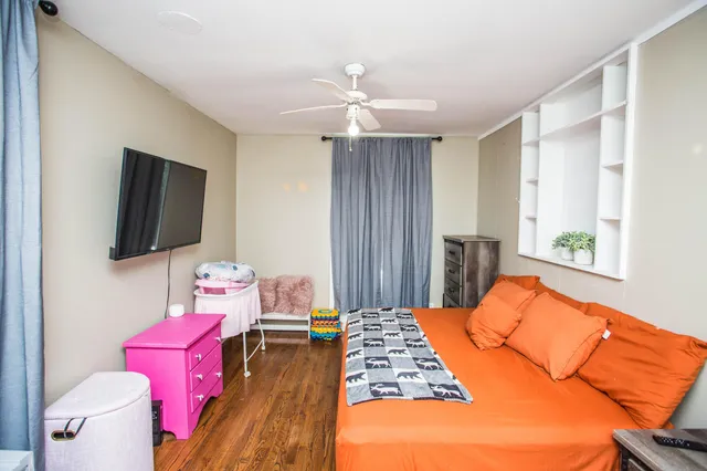 a bedroom with a bed and flat screen tv