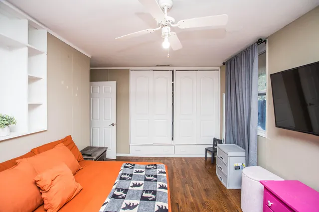 a bedroom with a bed and a flat screen tv