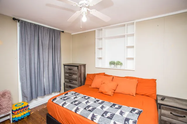 a bedroom with a bed and a chandelier