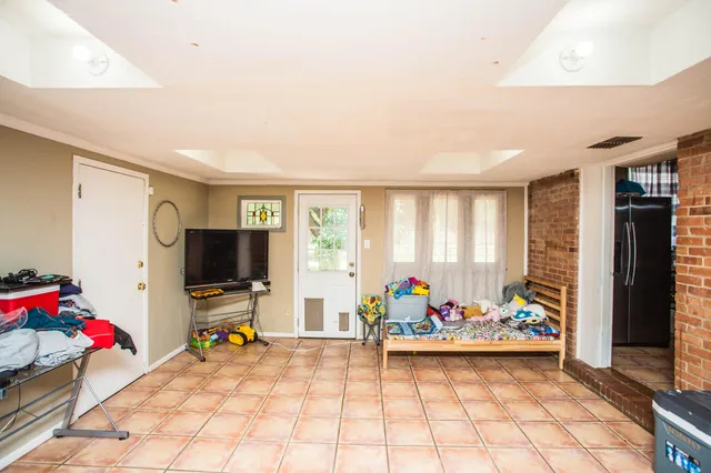 a view of a livingroom with workspace and a window
