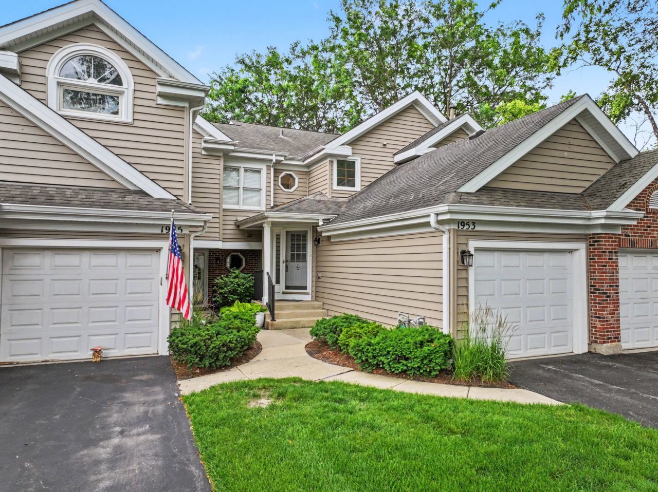 1953 North Coldspring Road Arlington Heights, IL 60004 - Photo 1 of 27 a front view of a house with a yard and garage