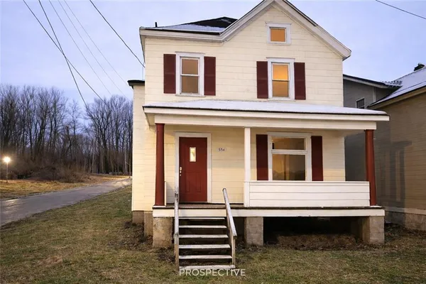 a view of a house with a yard and balcony