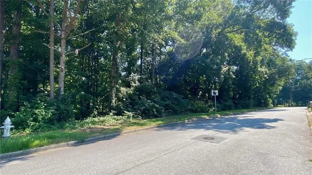 a view of a yard with large trees