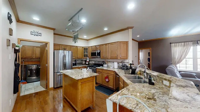 a kitchen with sink refrigerator and large window