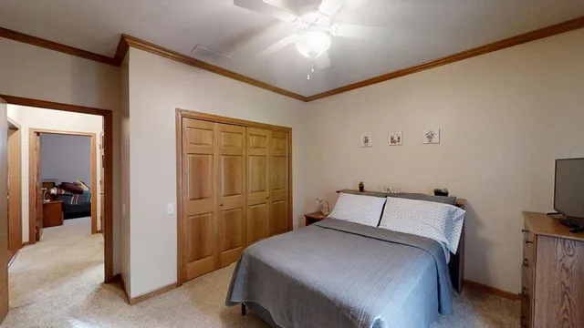 a bedroom with a bed and a chandelier