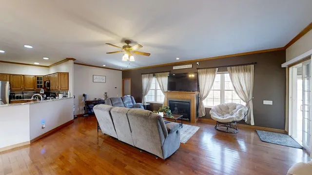 a living room with furniture a fireplace and a flat screen tv