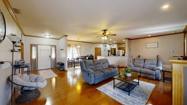a living room with furniture and a chandelier