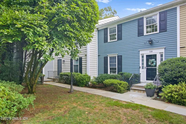 a house that has a tree in front of the house