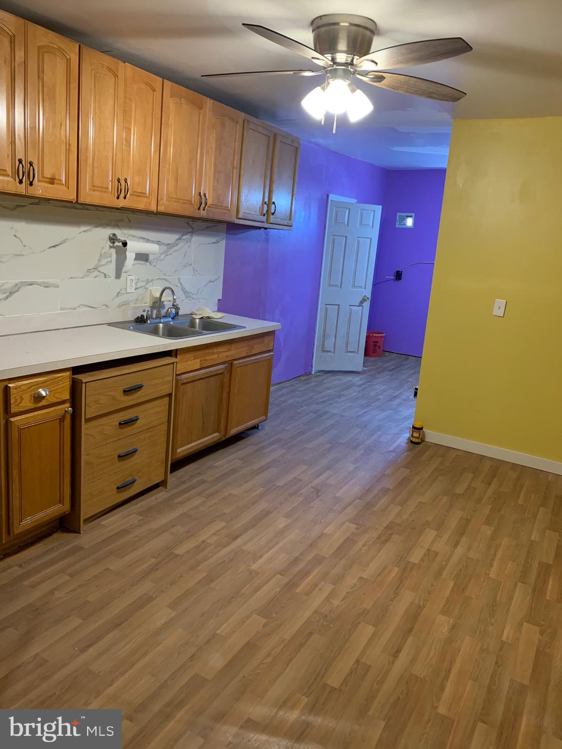 321 Highland Avenue Chester, PA 19013 - Photo 20 of 40 a kitchen with granite countertop a stove cabinets and wooden floor