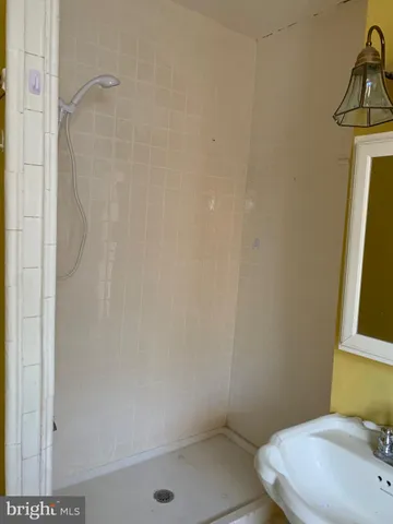 a bathroom with a sink toilet and mirror