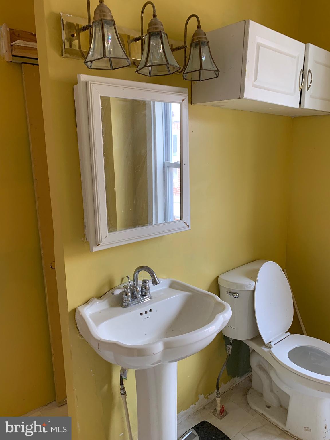 321 Highland Avenue Chester, PA 19013 - Photo 27 of 40 a bathroom with a sink a toilet and mirror