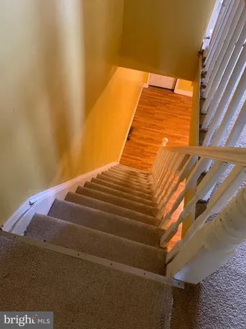 a kitchen with granite countertop cabinets and wooden floor