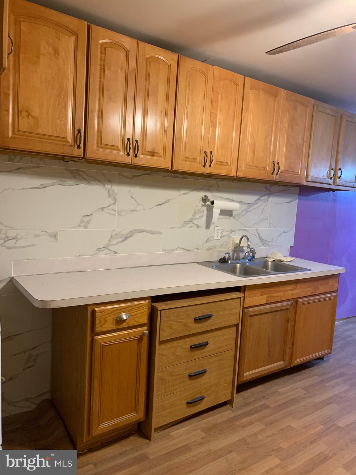 321 Highland Avenue Chester, PA 19013 - Photo 40 of 40 a kitchen with granite countertop cabinets and wooden floor