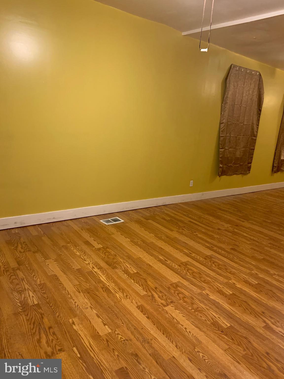 321 Highland Avenue Chester, PA 19013 - Photo 4 of 40 a view of a room with wooden floor and a chair