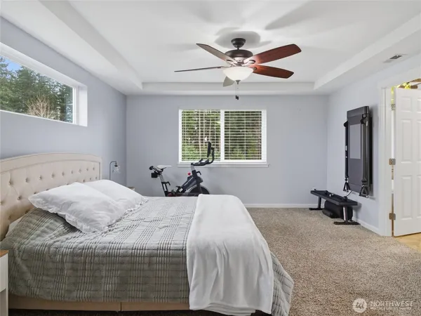 a bedroom with a bed and a chandelier