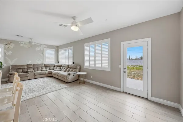 a living room with stainless steel appliances kitchen island granite countertop furniture and a kitchen view