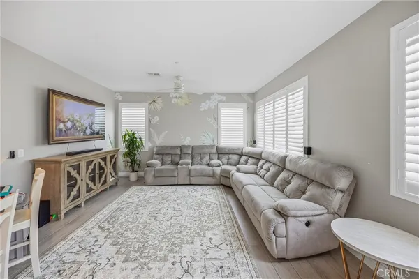 a bed room with furniture and a flat screen tv