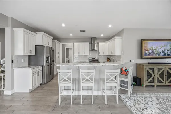 a kitchen with white cabinets and white appliances