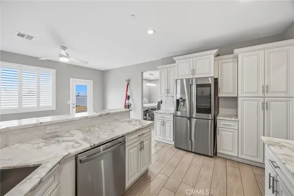 a kitchen with granite countertop a refrigerator and a sink