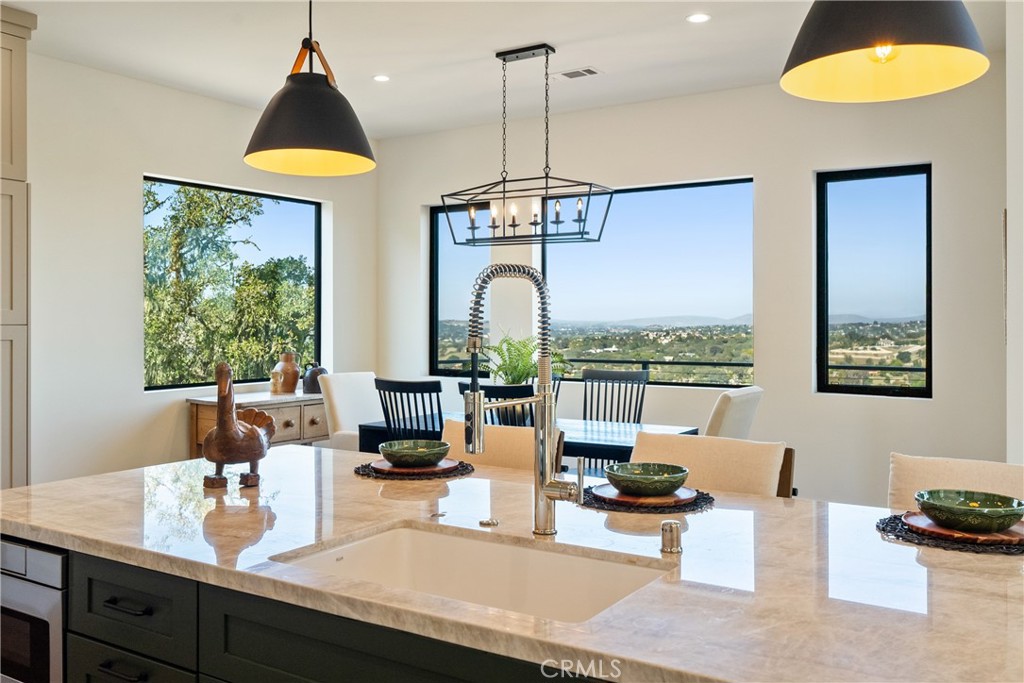2220 Battering Rock Road Templeton, CA 93465 - Photo 19 of 57 a kitchen with stainless steel appliances granite countertop a stove and white cabinets next to a window