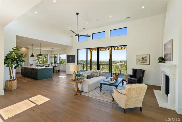 a living room with fireplace furniture and a large window