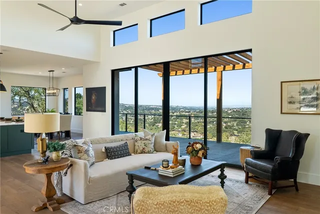 a living room with furniture and a floor to ceiling window