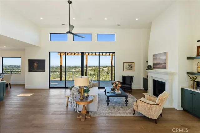a living room with fireplace furniture and a large window