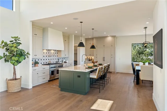 a kitchen with a table chairs sink and cabinets