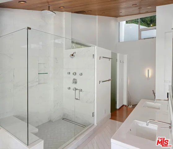 a bathroom with a shower and a sink