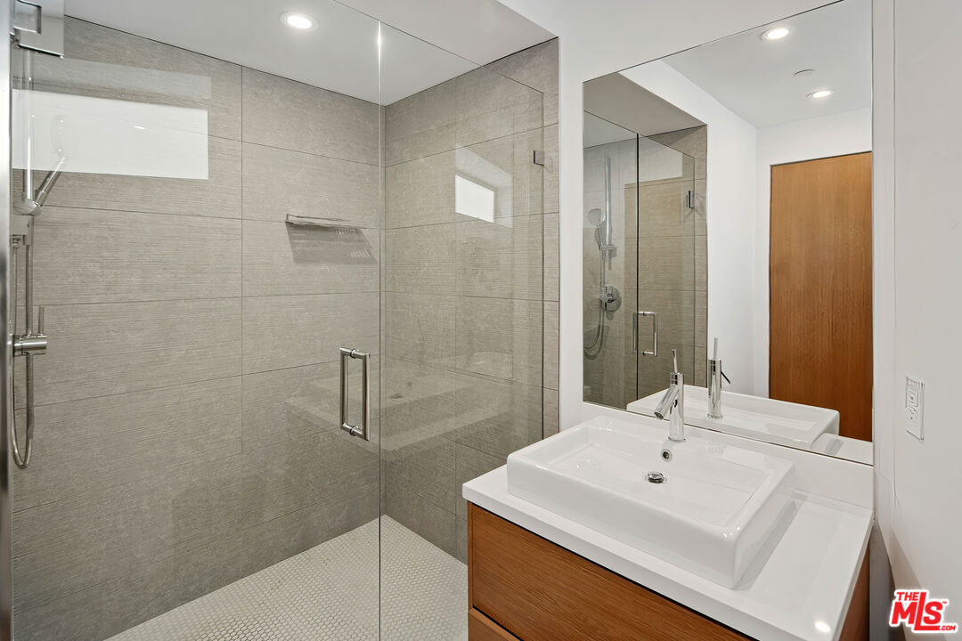 17405 Castellammare Drive Pacific Palisades, CA 90272 - Photo 18 of 29 a bathroom with a sink a shower and a mirror