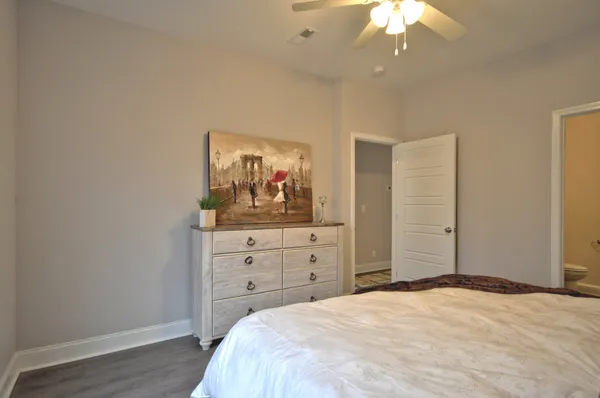 a bedroom with a bed and a dresser