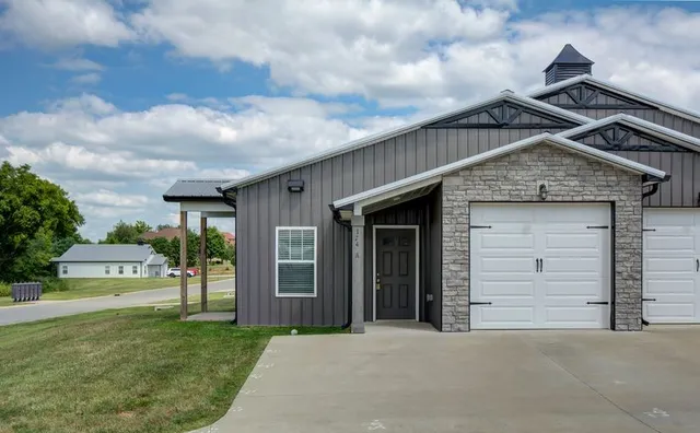 a front view of a house with a garden