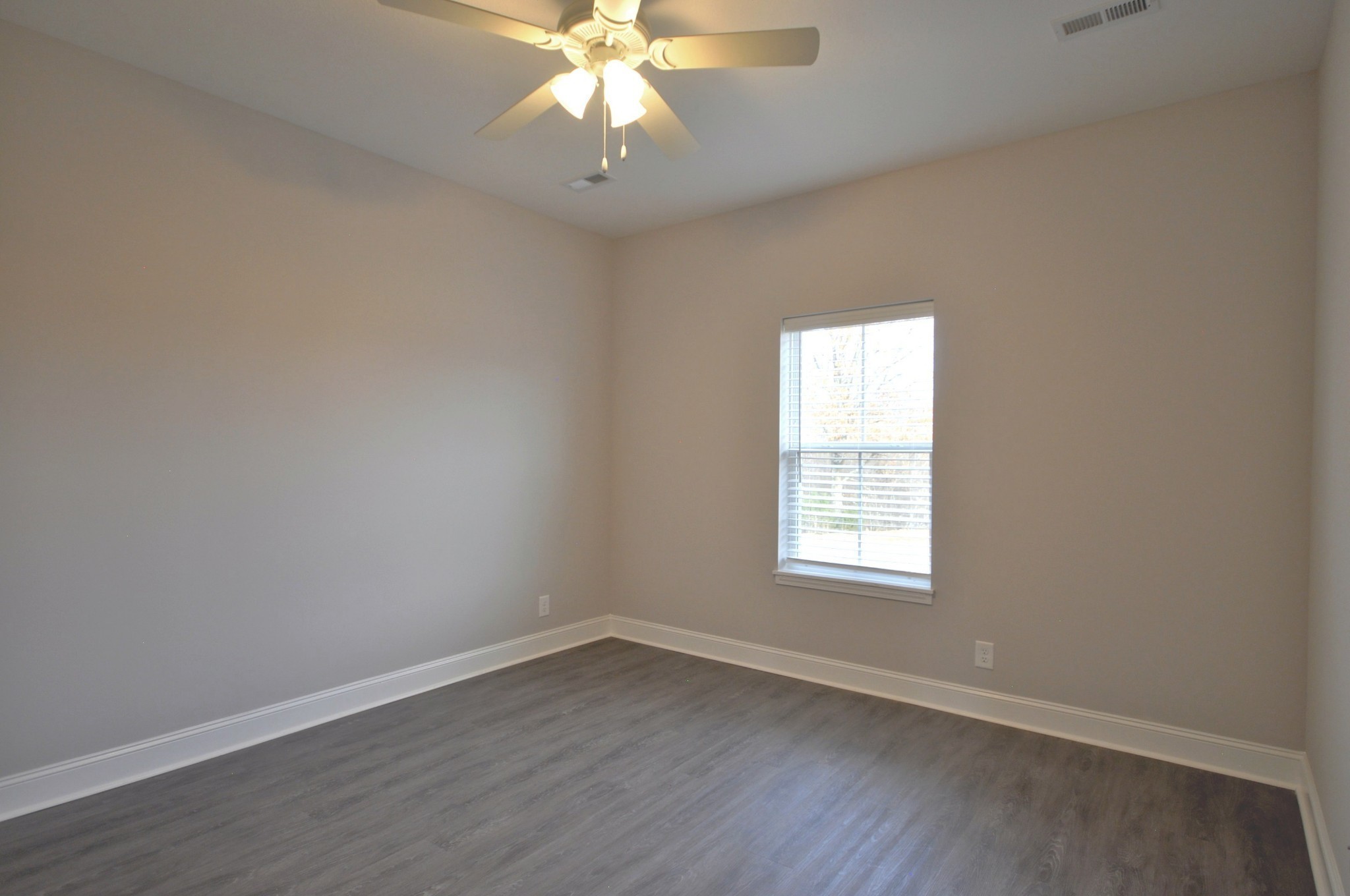 174 Bainbridge Drive, Unit A Clarksville, TN 37043 - Photo 26 of 36 an empty room with wooden floor and windows