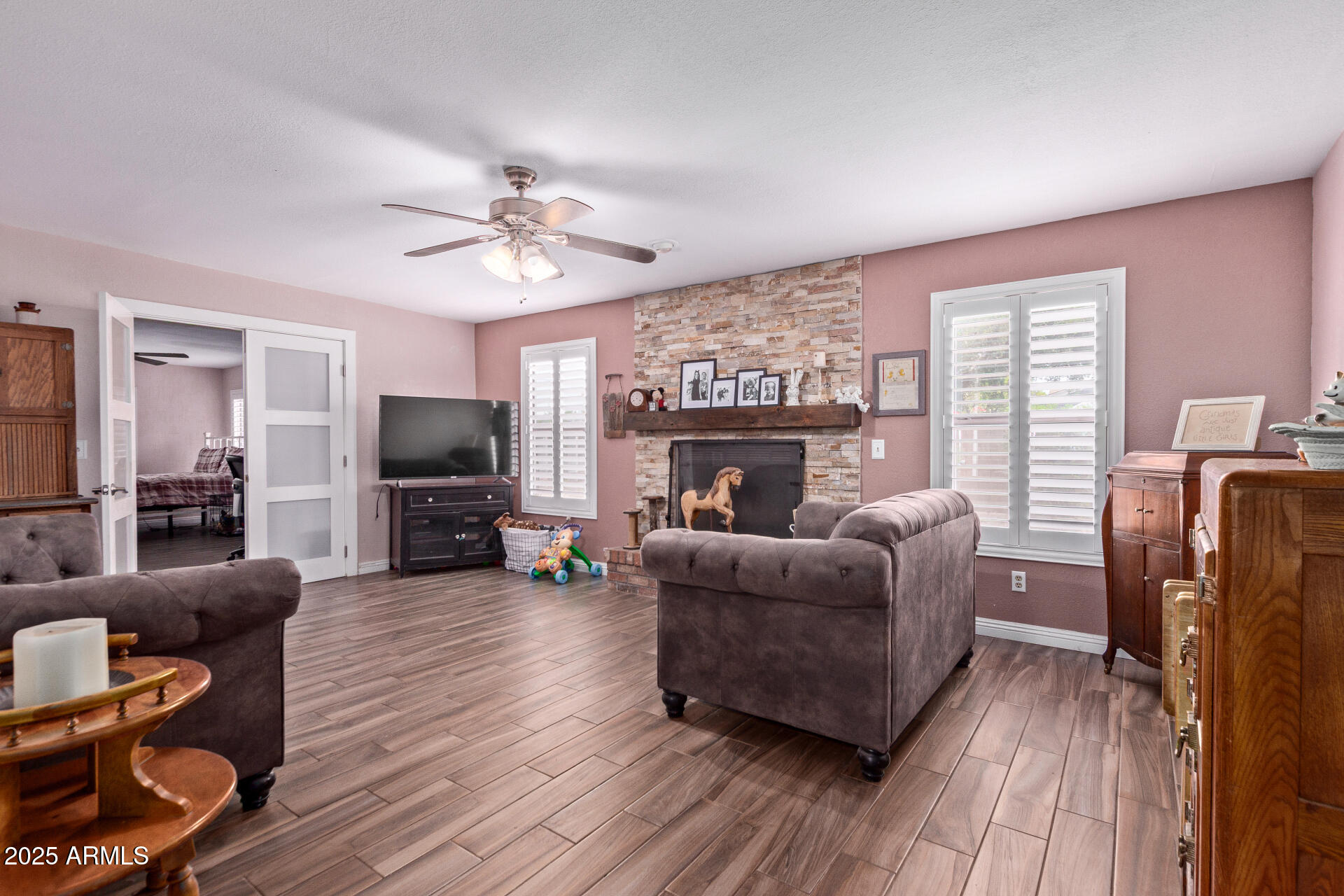 317 East Harwell Road Gilbert, AZ 85234 - Photo 11 of 29 a living room with furniture a flat screen tv and a fireplace
