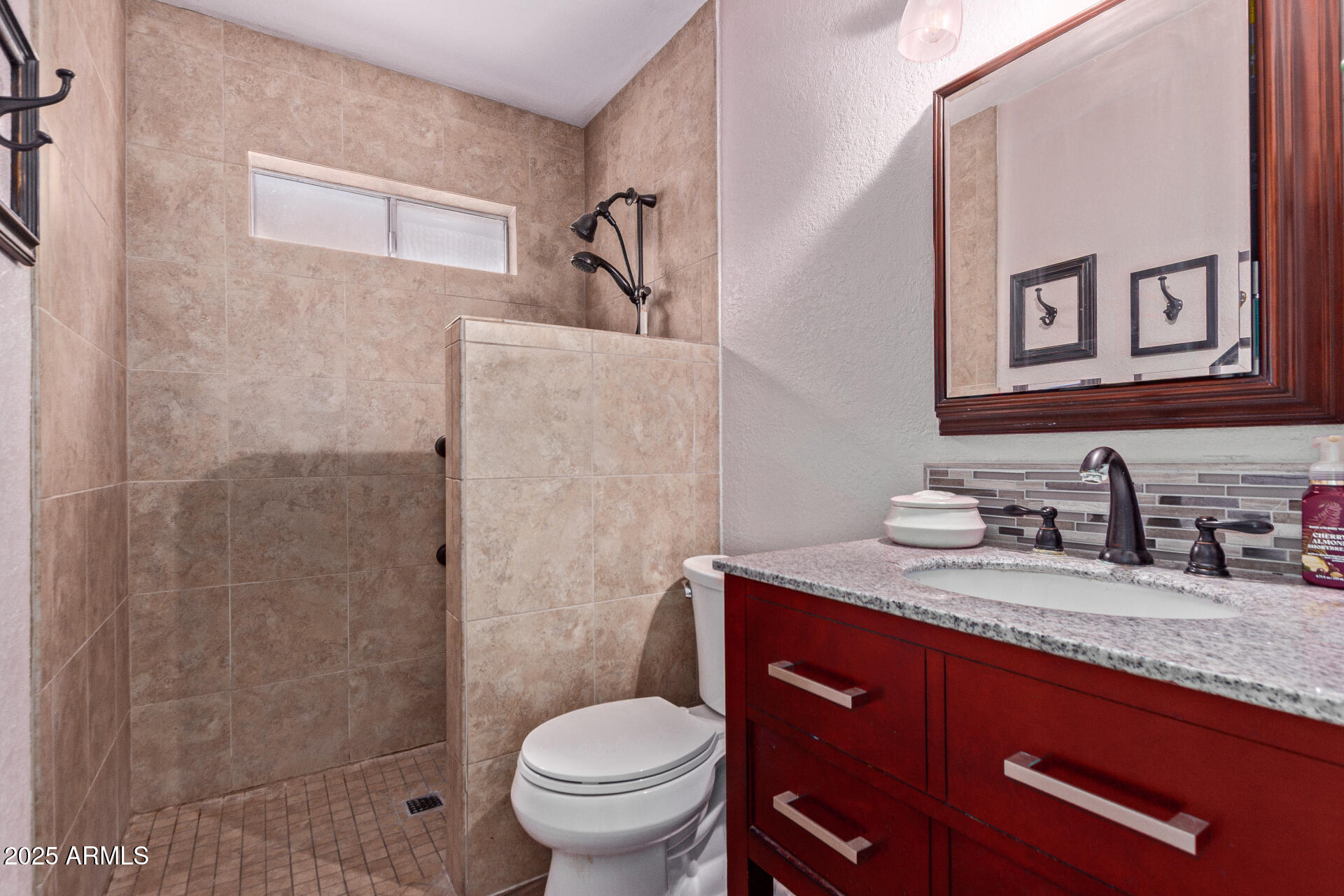 317 East Harwell Road Gilbert, AZ 85234 - Photo 18 of 29 a bathroom with a granite countertop toilet sink and mirror