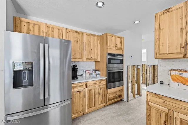 a kitchen with stainless steel appliances granite countertop a sink and a stove