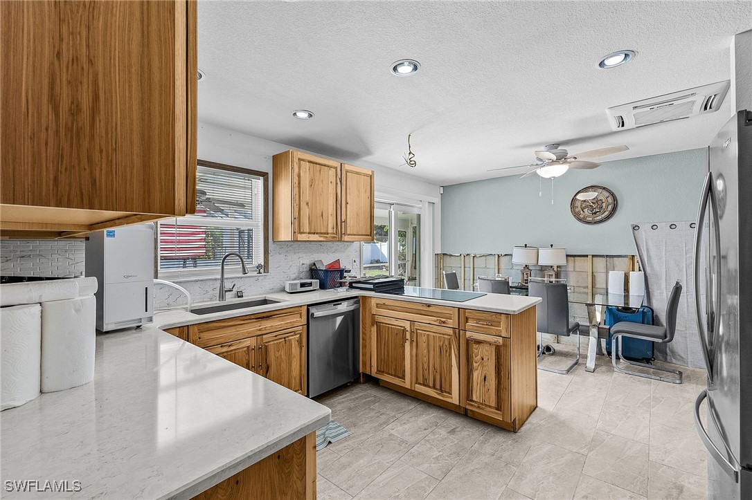 4826 East Riverside Drive Fort Myers, FL 33905 - Photo 13 of 34 a kitchen with stainless steel appliances granite countertop a sink and a stove