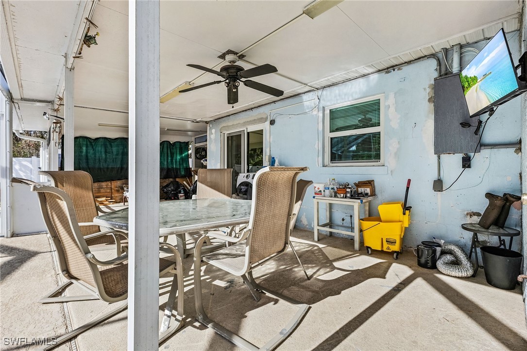 4826 East Riverside Drive Fort Myers, FL 33905 - Photo 23 of 34 a view of a dining room with furniture a chandelier and wooden floor