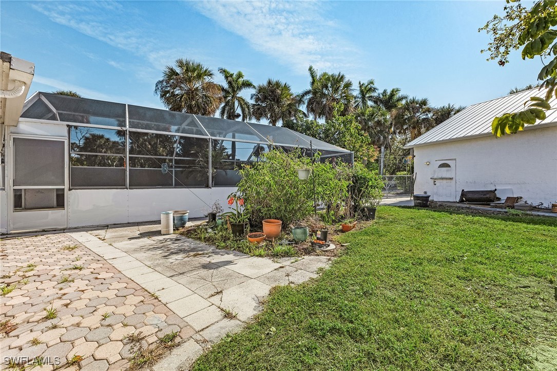 4826 East Riverside Drive Fort Myers, FL 33905 - Photo 28 of 34 a view of a backyard with table and chairs and potted plants