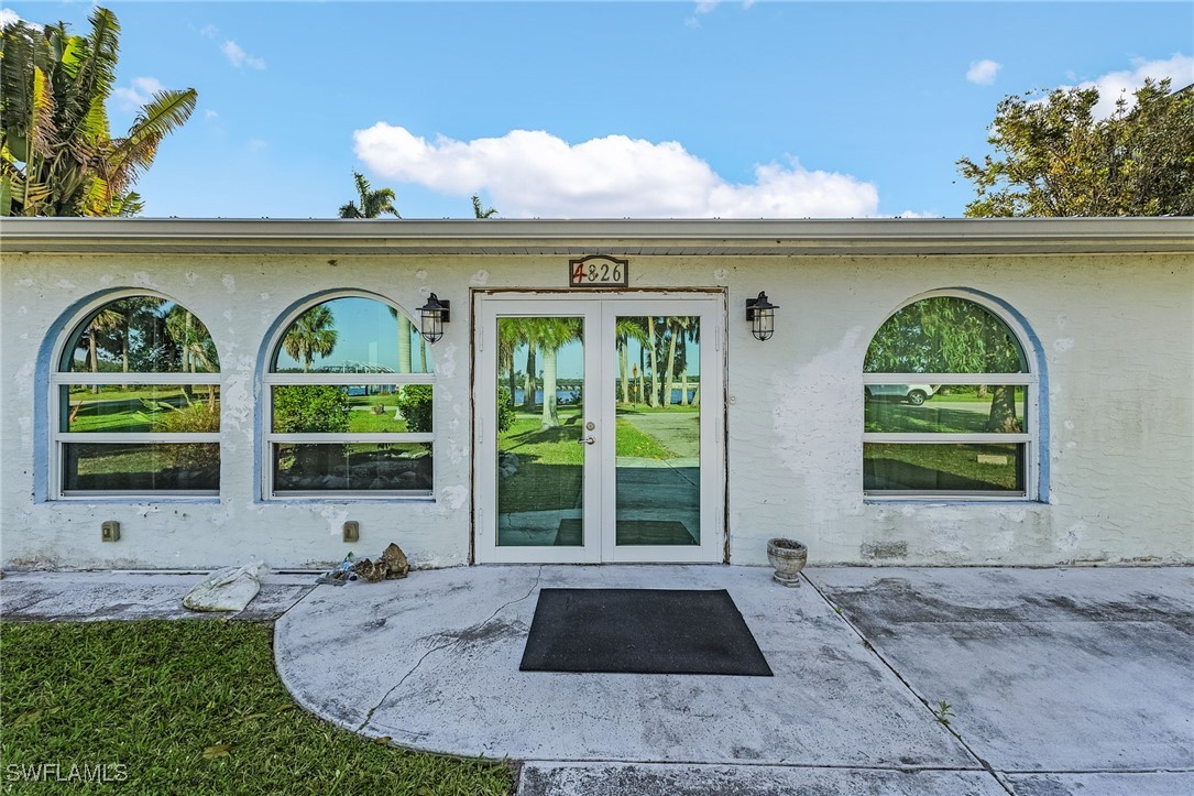 4826 East Riverside Drive Fort Myers, FL 33905 - Photo 31 of 34 a front view of a house with garden