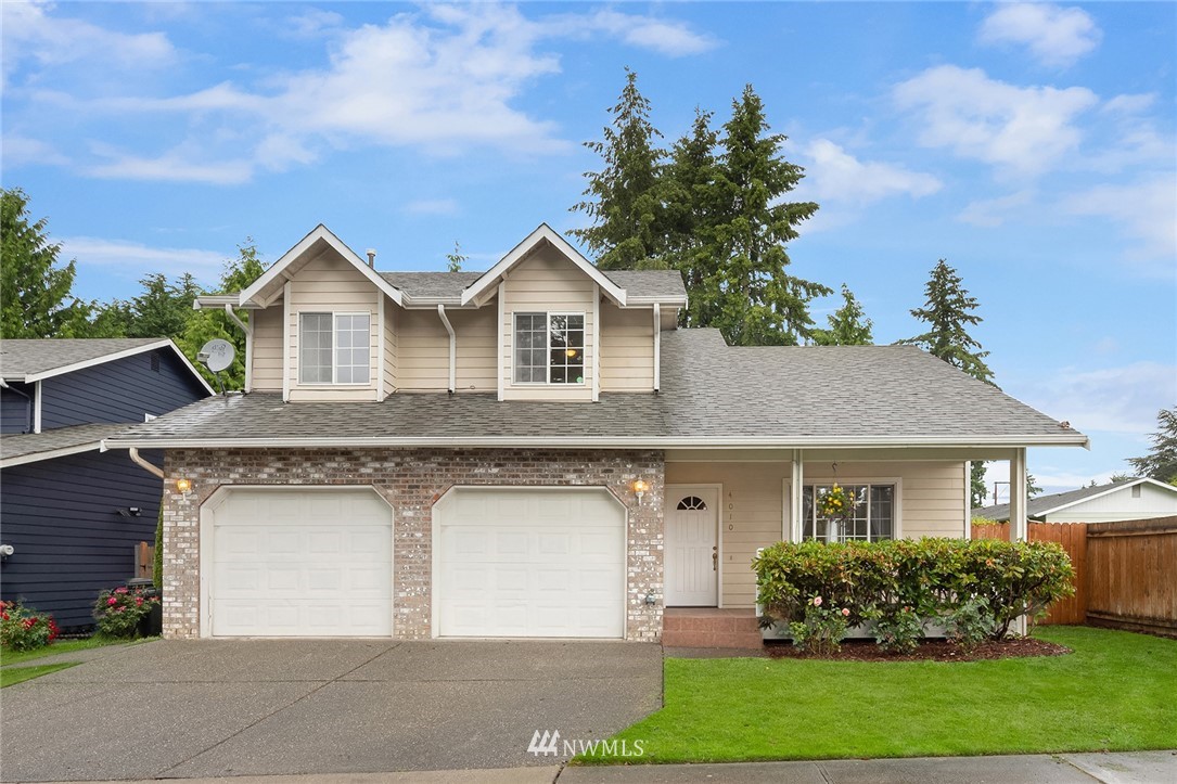 4010 Northeast 19th Street Renton, WA 98056 - Photo 1 of 25 a front view of a house with a garden