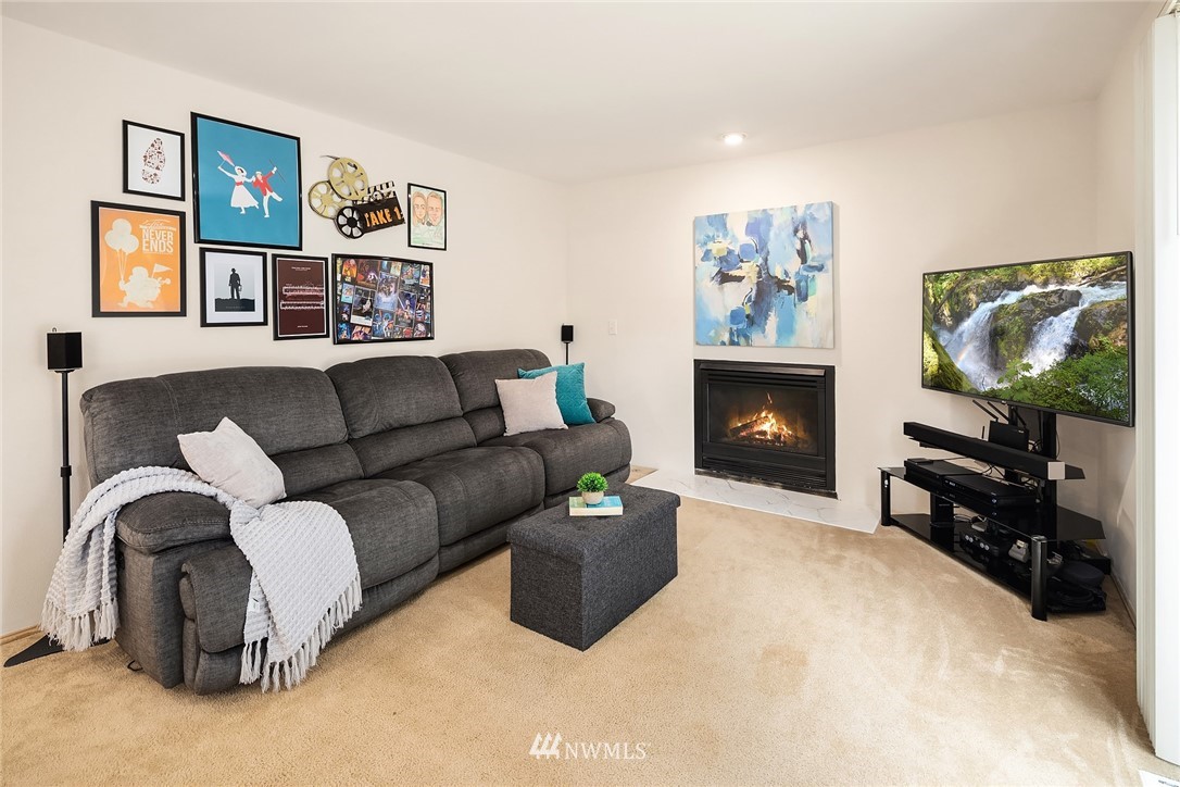 4010 Northeast 19th Street Renton, WA 98056 - Photo 11 of 25 a living room with furniture a flat screen tv and a fireplace