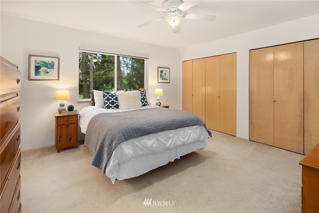 4010 Northeast 19th Street Renton, WA 98056 - Photo 15 of 25 a bedroom with a large bed and a chandelier