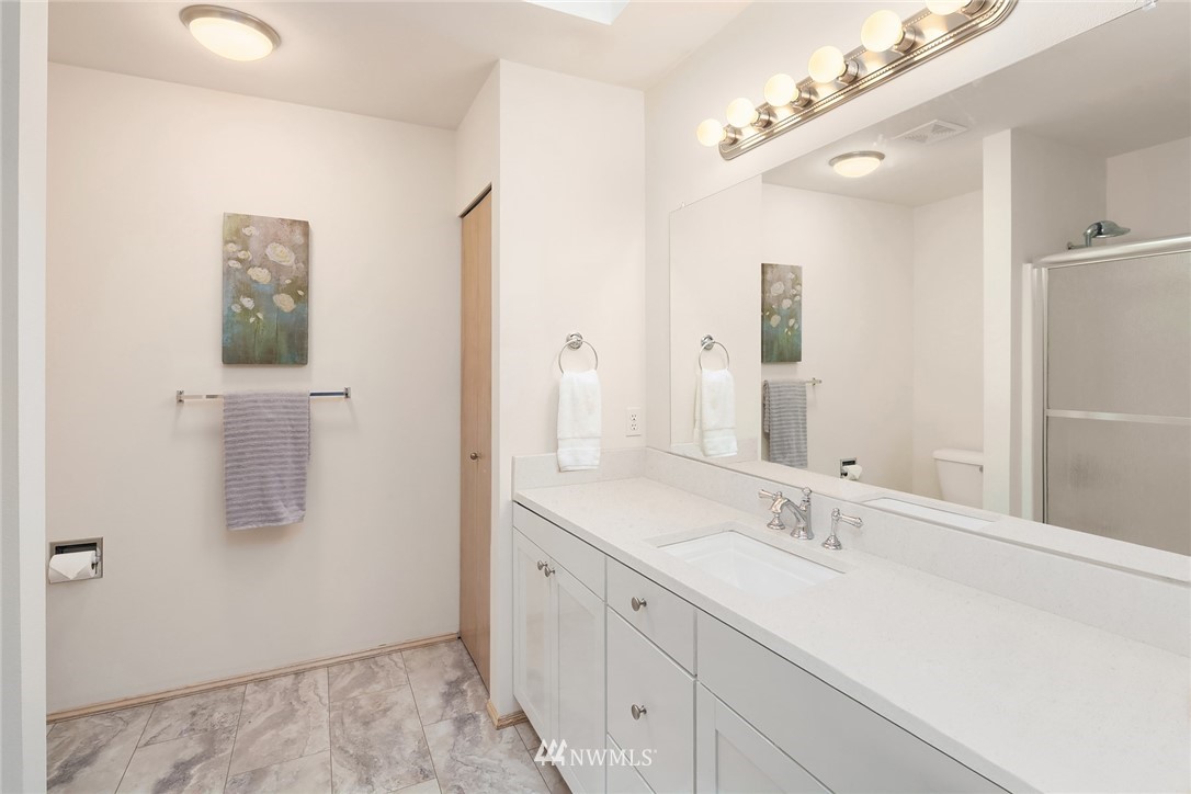 4010 Northeast 19th Street Renton, WA 98056 - Photo 17 of 25 a bathroom with a double vanity sink a mirror and shower
