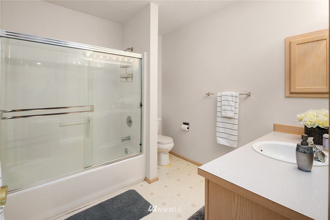 4010 Northeast 19th Street Renton, WA 98056 - Photo 20 of 25 a bathroom with a granite countertop sink a toilet and shower