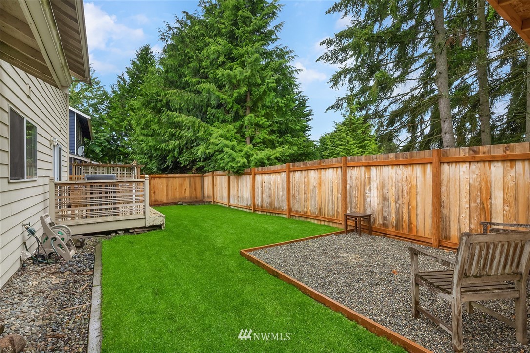 4010 Northeast 19th Street Renton, WA 98056 - Photo 22 of 25 a view of a backyard with wooden fence and a bench